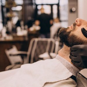 man-at-barbershop-salon-doing-haircut-and-beard-trim-scaled-pmvhxrxw6cueeg9bxvgkmxy1fylhzufa35lqem42gs